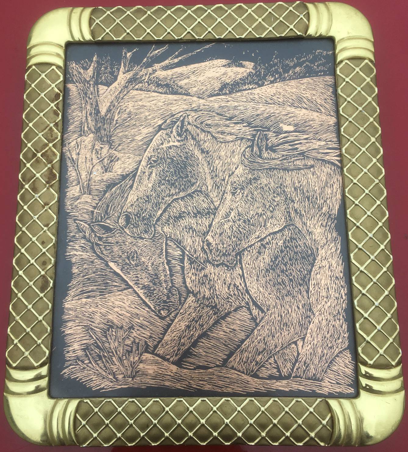 three horses running in a meadow engraved into a copper sheet